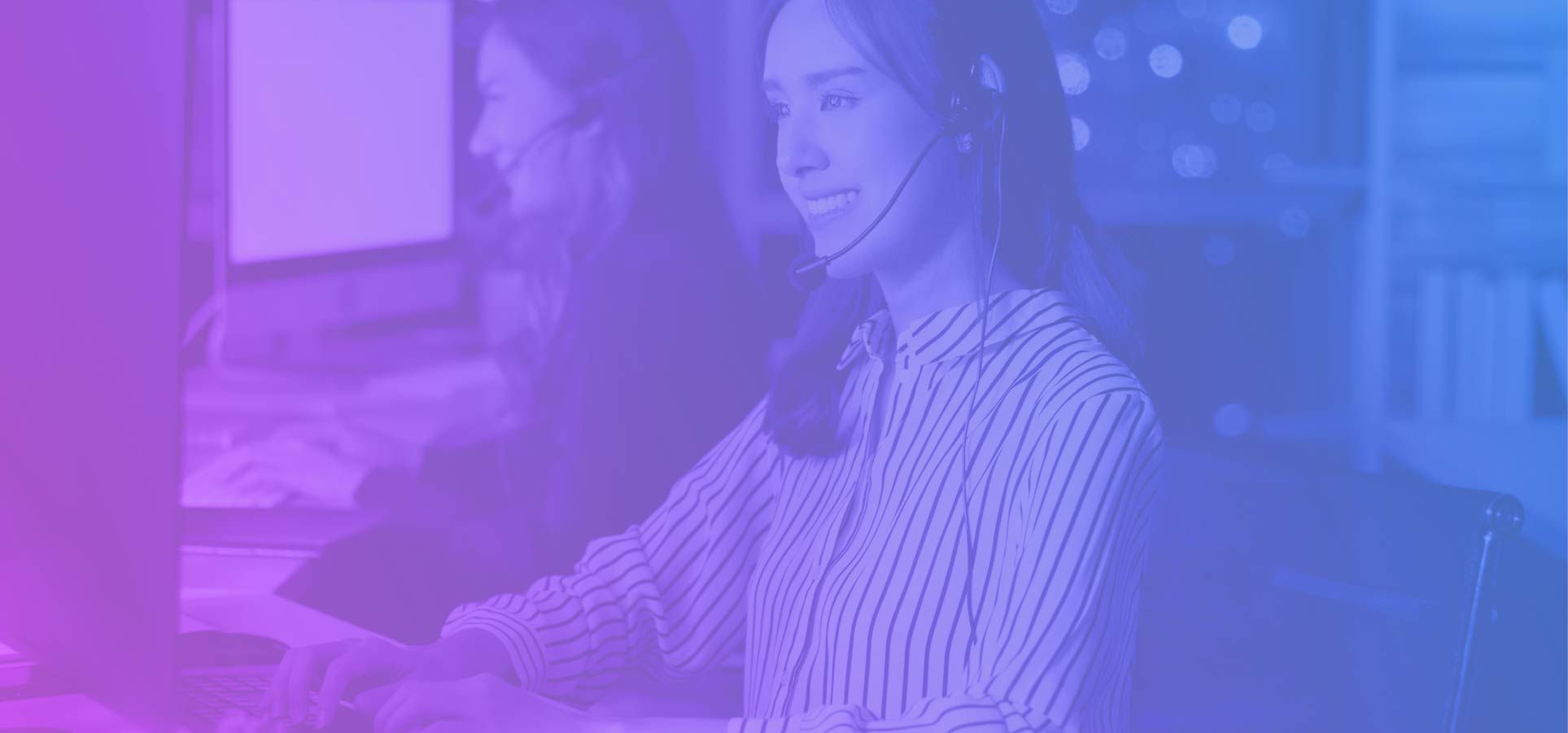 Customer service agent wearing headset working at call center desk